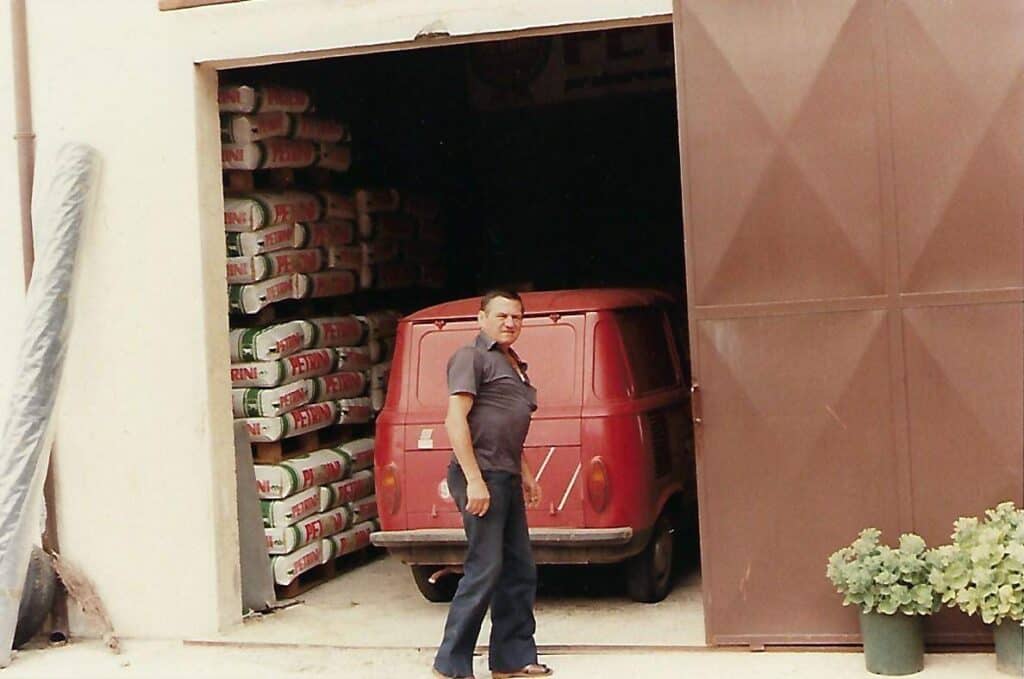 Immagine di un uomo vicino a un veicolo rosso in un'area di stoccaggio.