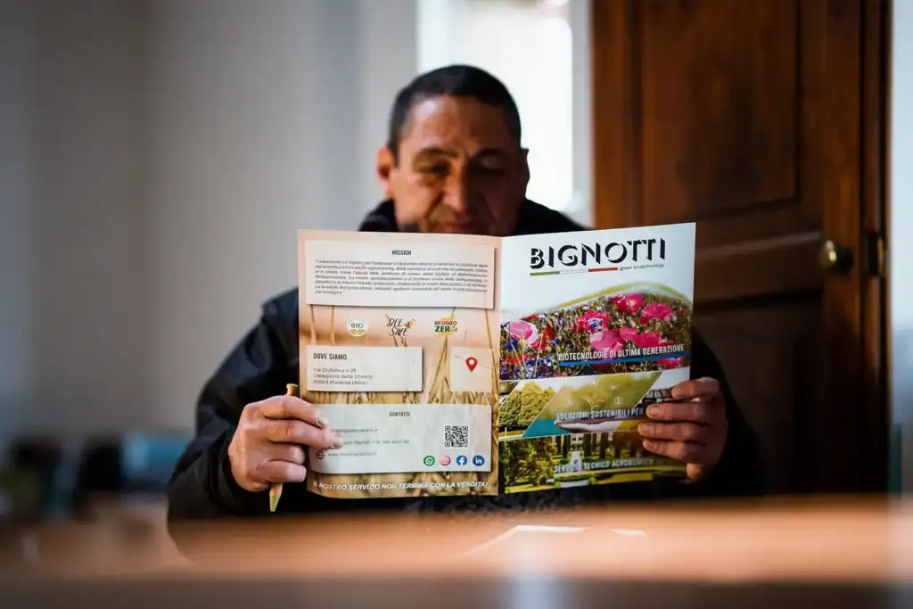 Persona che sfoglia un opuscolo di Bignotti Greenbiotechnology.